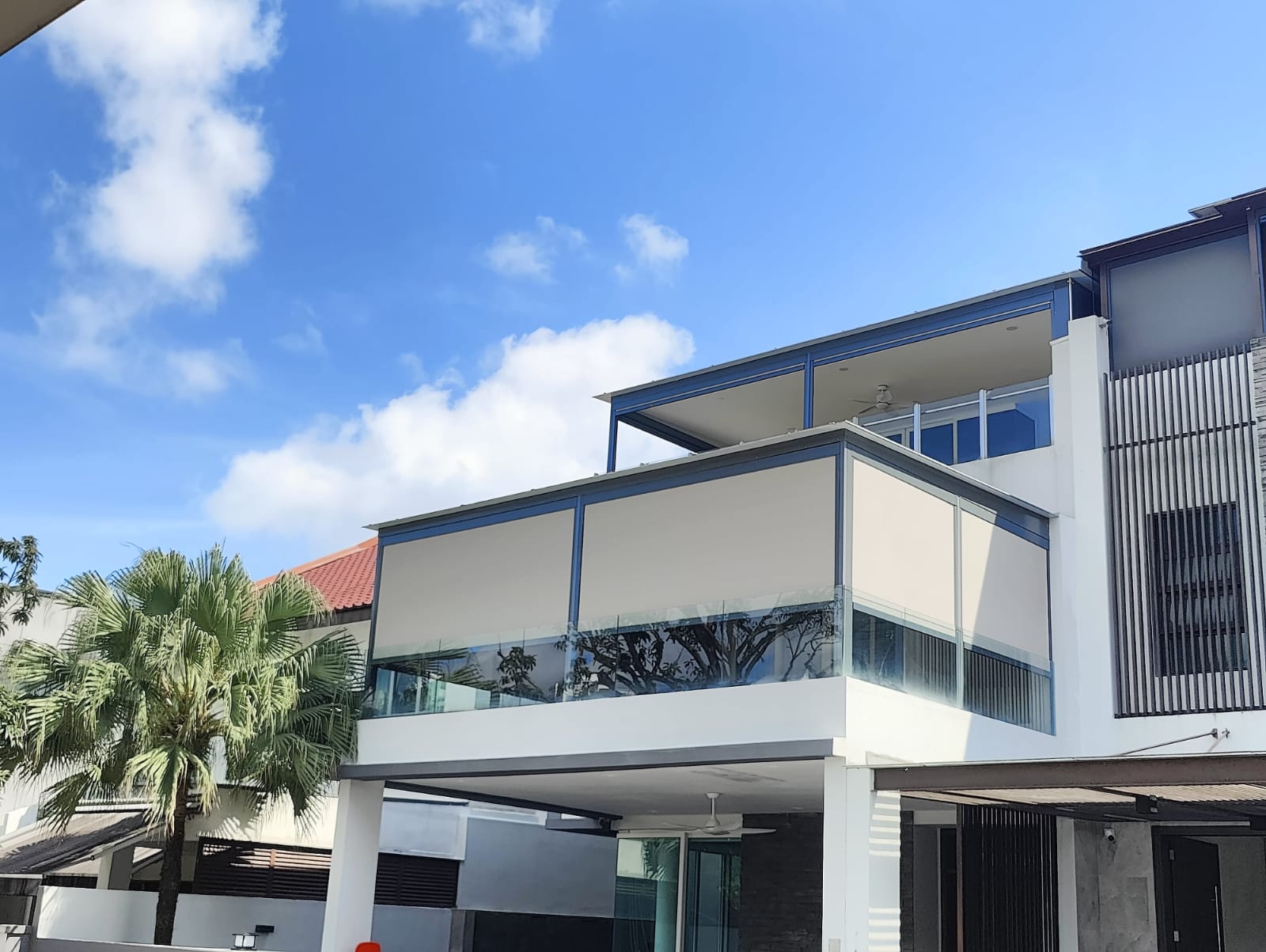 Motorised zip blinds on a Singapore condo balcony, partially lowered