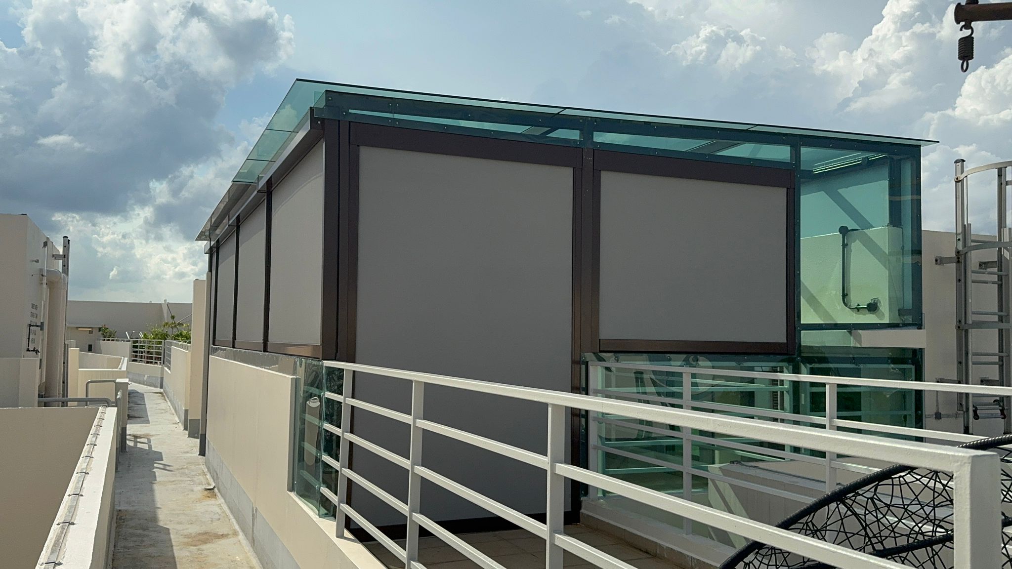 Zip blinds providing shade over an outdoor lounge area